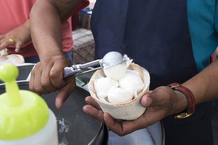 Scoop Ice cream to the young coconutの写真素材