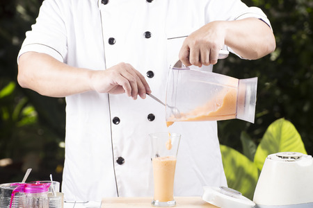 Chef pouring Thai Tea smoothie to the glass