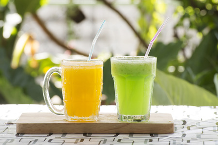 Green Apple and Orange Smoothie on the tableの写真素材