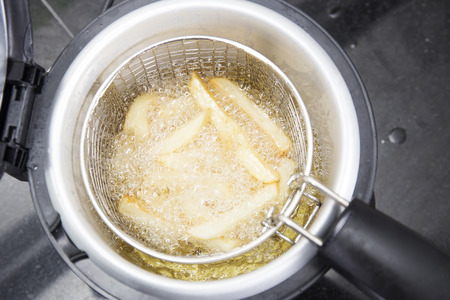 French fried in hot vegetable oil on electronic potの写真素材