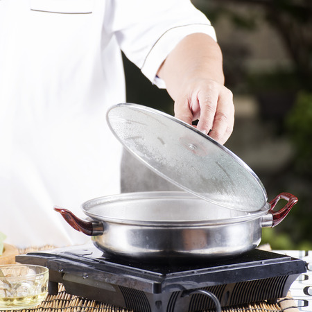 Chef opening the lid of pot before cooking noodle  Cooking Noodle conceptの写真素材
