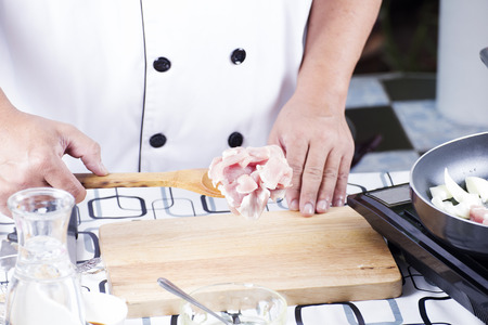 Chef putting slice pf pork to the pan for cooking Japanese pork curry  cooking Japanese pork curry conceptの写真素材