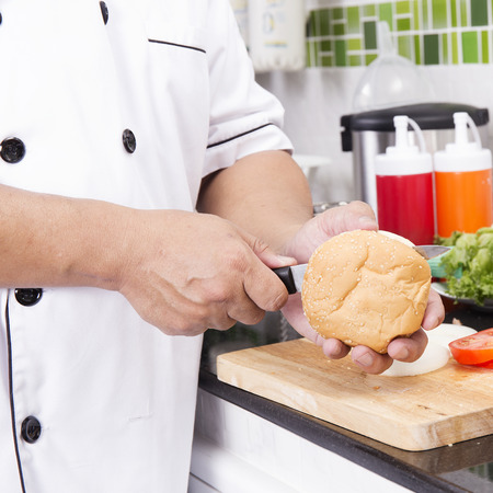 Chef shred burger bun with knife  cooking Hamburger conceptの写真素材