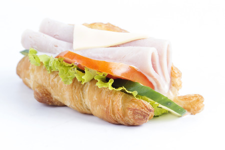 croissant sandwich with ham cheese on white backgroundの写真素材