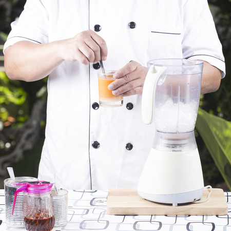 Stir hot Thai Tea before Thai Tea smoothieの写真素材