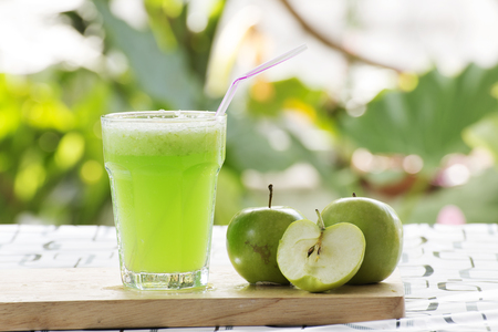 Glass of Green Apple smoothie on the tableの写真素材