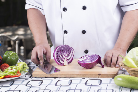 Chef cutting purple cabbage before cookingの写真素材