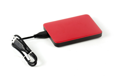 Red External Hard Drive and cable isolated on white