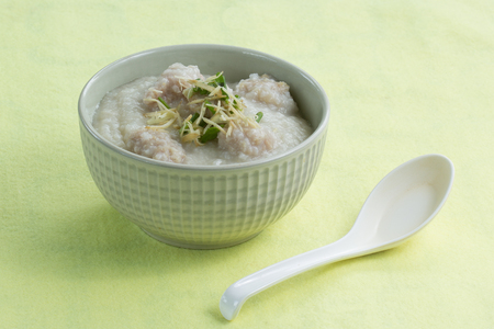 Traditional chinese porridge rice gruel in bowl with porkの写真素材
