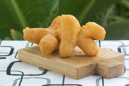 deep fried dough stick on the wooden trayの写真素材