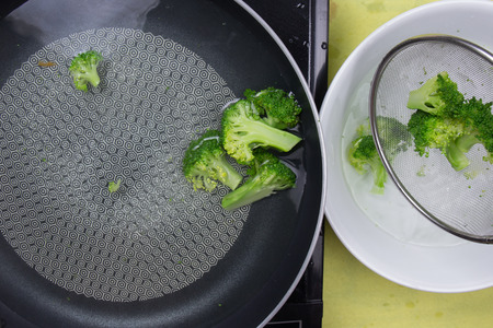 Chef scald broccoli with hot water / cooking steak conceptの写真素材
