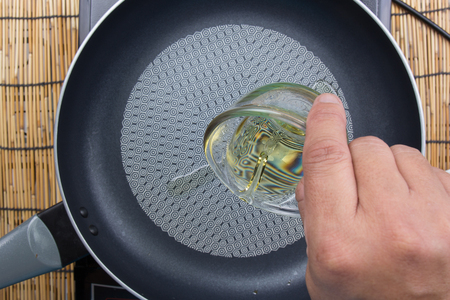 Chef putting oil to pan / cooking fried rice conceptの写真素材