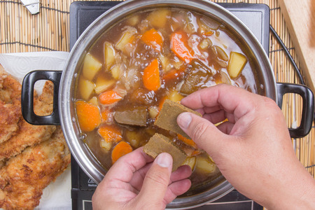 Chef putting Japanese curry pasted for cooking / cooking Japanese pork curry paste conceptの写真素材