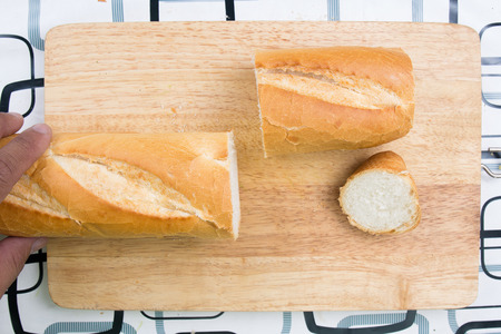 Chef slicing bread / cooking sausage bread concept