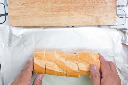 Chef put sausage bread to foil / cooking sausage  bread concept
