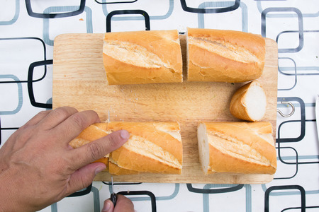 Chef slicing bread / cooking sausage bread conceptの写真素材