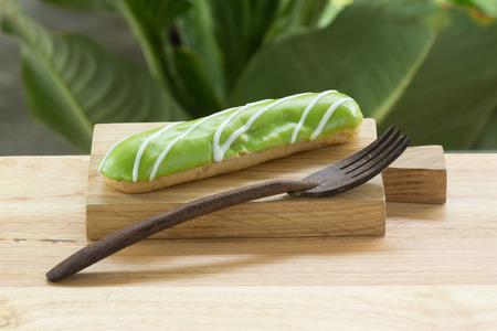 Melon dessert eclair on the wooden plateの写真素材