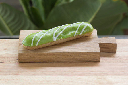 Melon dessert eclair on the wooden plateの写真素材