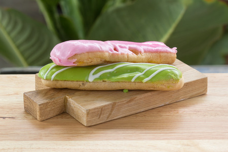 Strawberry and Melon  dessert eclair on the wooden plate