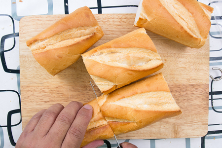 Chef slicing bread / cooking sausage bread concept