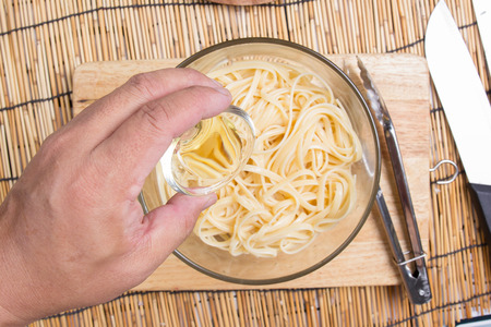 Put oil to Spaghetti / cooking spaghetti conceptの写真素材
