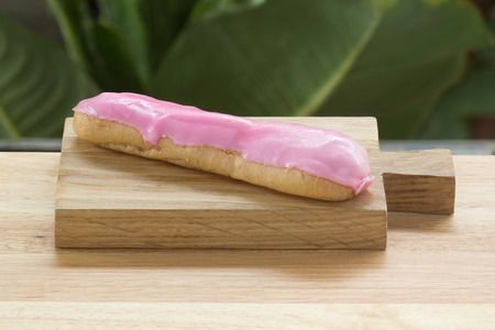 Strawberry dessert eclair on the wooden plateの写真素材