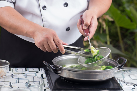 Chef scald broccoli with hot water / Stir fry Broccoli conceptの写真素材