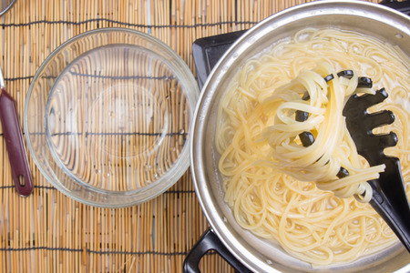 Spaghetti lifted on of cold water / cooking spicy spaghetti conceptの写真素材