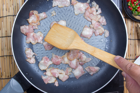 Chef stir fried bacon in the pan / cooking spicy spaghetti conceptの写真素材