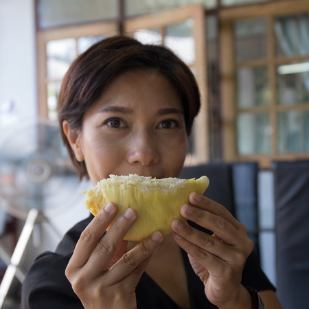 Asian Nice Woman holding piece of Durianの写真素材
