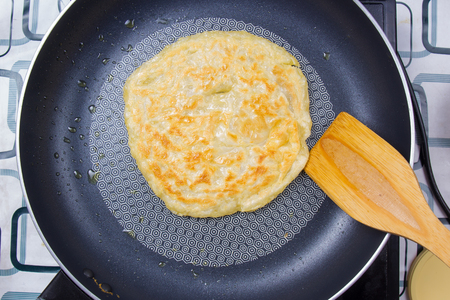 Chef cooking roti in the pan home mate style / Cooking green curry conceptの写真素材