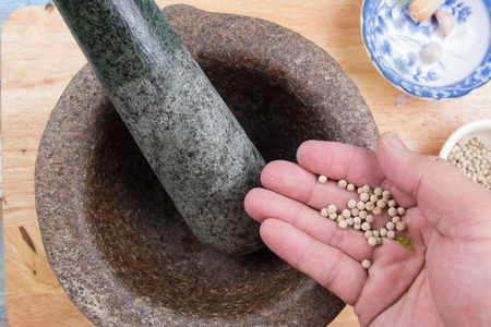 Chef putting pepper to mortar / Cooking sweet brown Stewed pork gravy (Moo Pa-lo) conceptの写真素材