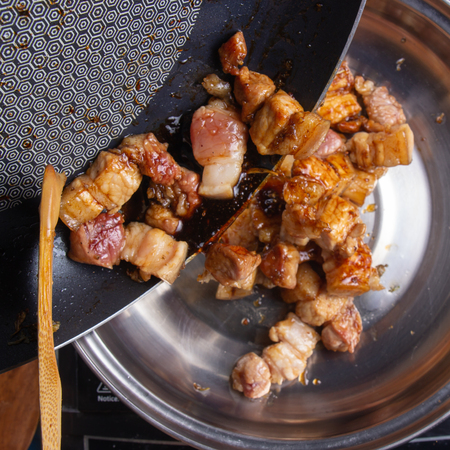 Chef putting cooked streaky pork to pot / Cooking sweet brown Stewed pork gravy (Moo Pa-lo) conceptの写真素材