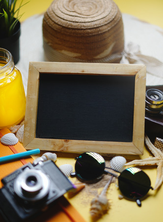 Empty Space Blackboard Between Summer Beach Accessories on Yellow Background - Room For Textの写真素材