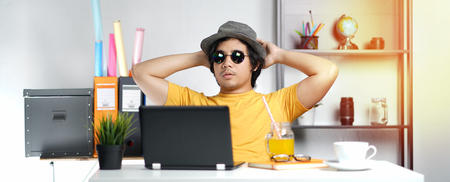 Young Professional Enjoying His Holiday While Working on Summer Vacation at Office