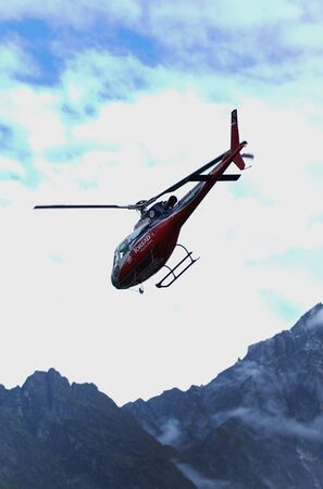 LUKLA, NEPAL - 20 SEPTEMBER 2017: Red Helicopter Leaving TenzingâHillary Airportのeditorial素材