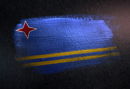 Aruba Flag Made of Metallic Brush Paint on Grunge Dark Wallの写真素材