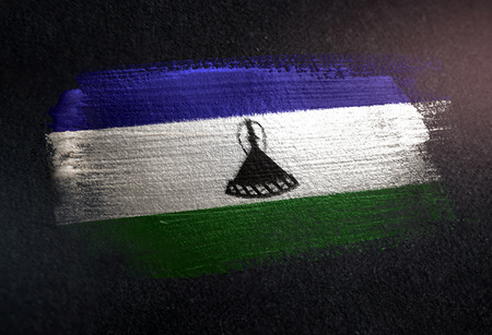 Lesotho Flag Made of Metallic Brush Paint on Grunge Dark Wallの写真素材