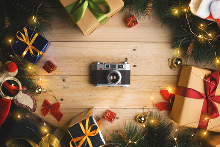 Top View of Vintage Camera Between Christmas Ornament on Wooden Textureの写真素材