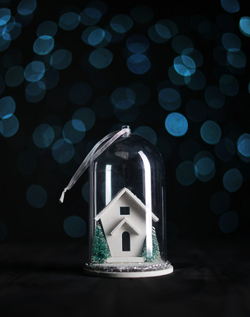 Christmas Ornament, White House inside Glass, Blue Bokeh Dark Backgroundの写真素材