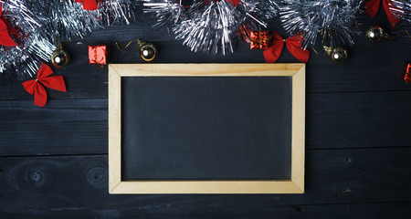 Blackboard Copy Space. Silver Christmas Ornament on Black Wood Plank. Top Viewの写真素材