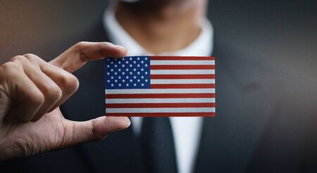 Businessman Holding Card of United States of America Flagの写真素材