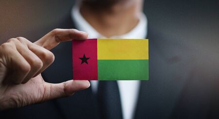 Business man Holding Card of Guinea-Bissau Flagの写真素材