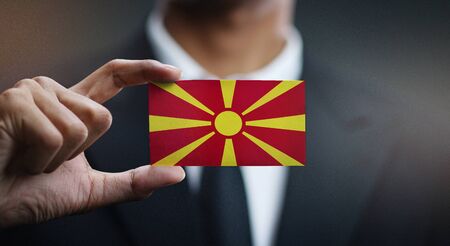 Business man Holding Card of Republic of Macedonia Flagの写真素材