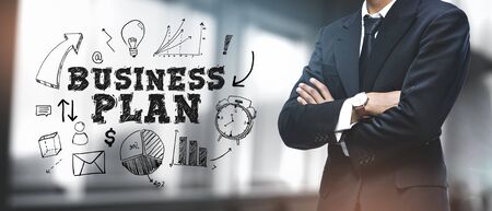 Asian Businessman on Blurred Office Background. "Business Plan" Sketch Concept の写真素材