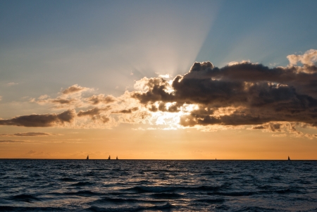 sailing boat in front of the sunの写真素材