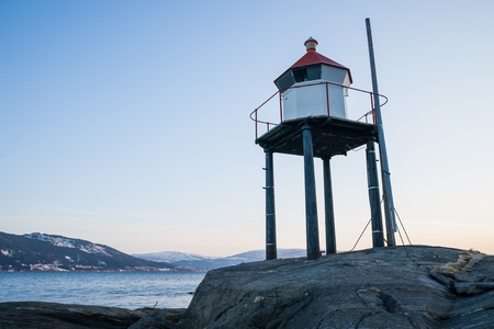 little lighthouse near a fjord in norwayの写真素材