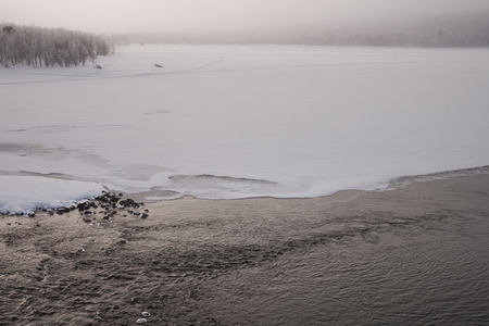 fog over a frozen river in sweden