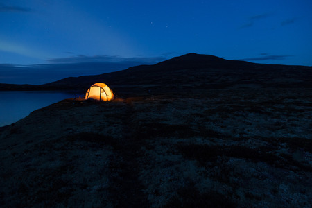 Iluminated tent at night in Norway