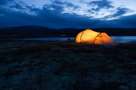 Iluminated tent at night in Norwayの写真素材